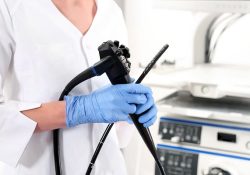 Medical professional holding a colonoscope device used in colonoscopy procedures for detecting polyps and preventing colorectal cancer